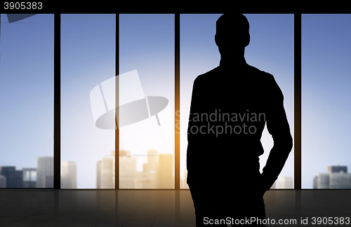 Image of silhouette of business man over office background