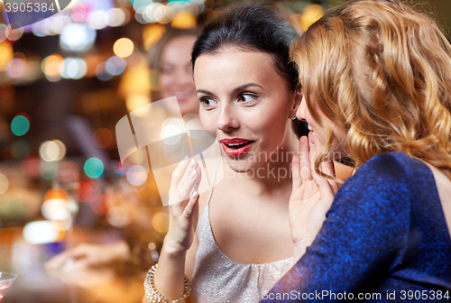 Image of happy women with drinks at night club