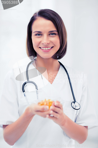 Image of doctor holding bowl of capsules