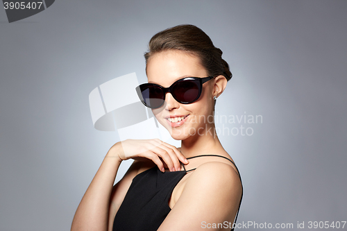 Image of beautiful young woman in elegant black sunglasses