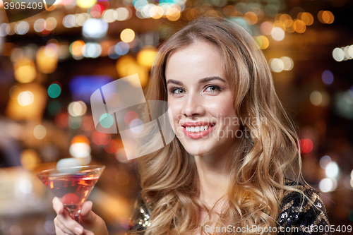 Image of glamorous woman with cocktail at night club or bar