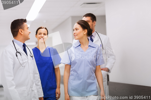 Image of happy group of medics or doctors at hospital