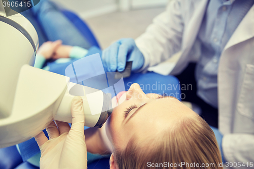 Image of dentist and patient with dental x-ray machine