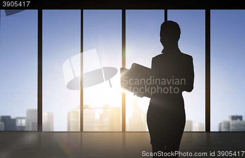 Image of silhouette of business woman with folders