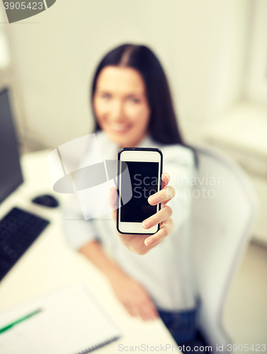 Image of close up of woman showing smartphone at office