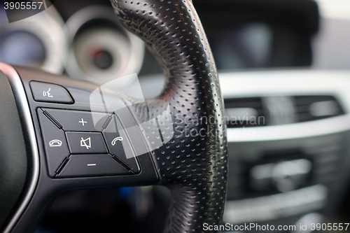 Image of Steering wheel of  car, details of phone adjustment controls