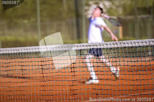 Image of Tennis net Man plays tennis