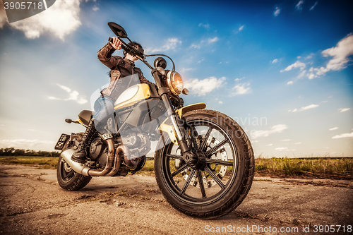 Image of Biker girl on a motorcycle