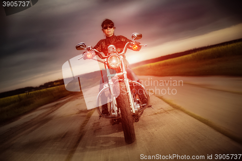 Image of Biker girl on a motorcycle