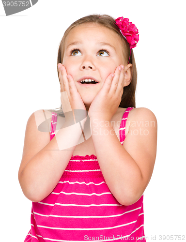 Image of Little girl is holding her face in astonishment