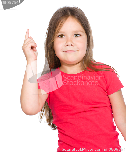 Image of Cute little girl is pointing up