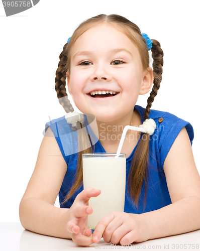 Image of Cute little girl with a glass of milk