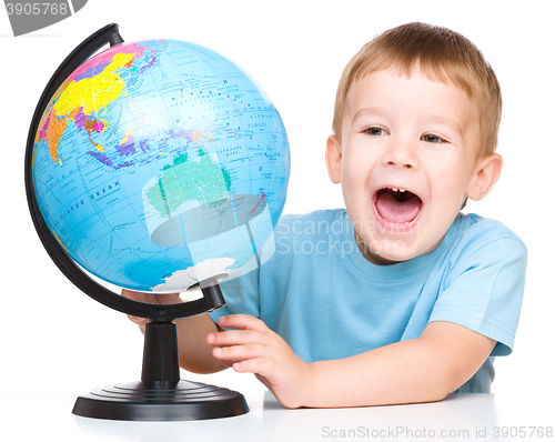 Image of Happy little boy with a globe