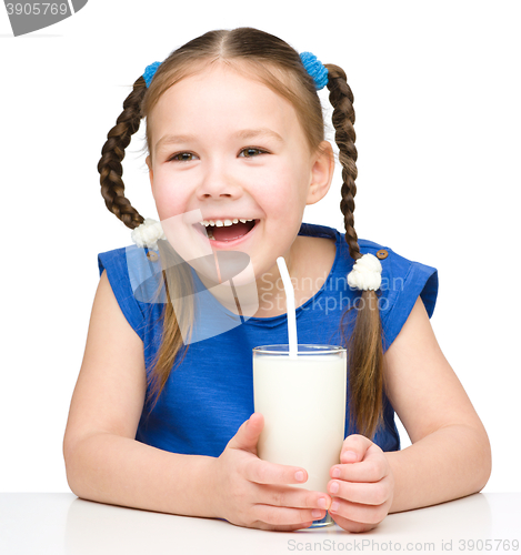 Image of Cute little girl with a glass of milk