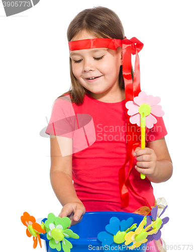 Image of Cute little girl wit a bunch of flowers