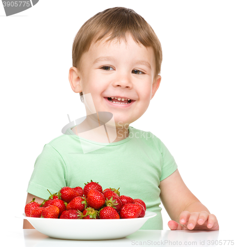 Image of Happy little boy with strawberries