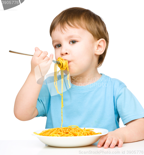 Image of Little boy is eating spaghetti
