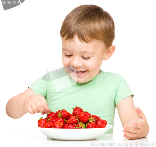 Image of Happy little boy with strawberries