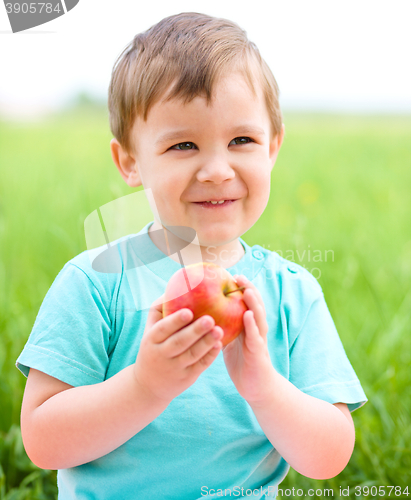 Image of Portrait of a happy little boy with apple