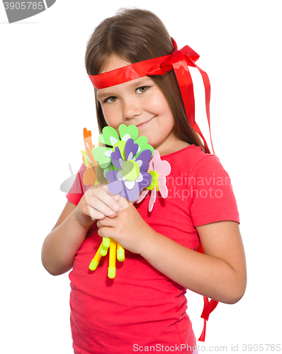 Image of Cute little girl wit a bunch of flowers