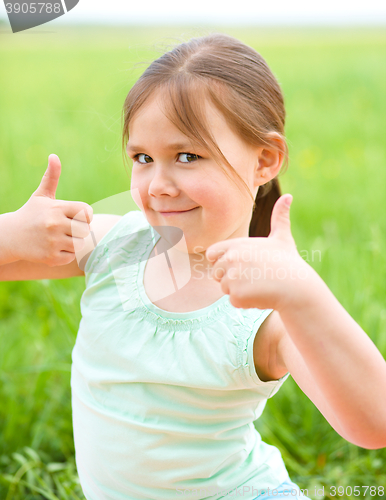 Image of Little girl is showing thumb up gesture