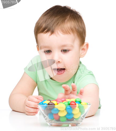 Image of Portrait of a boy with candies