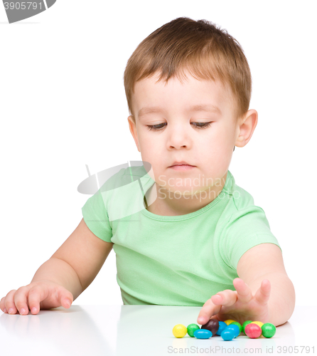 Image of Portrait of a boy with candies