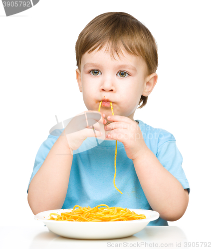 Image of Little boy is eating spaghetti