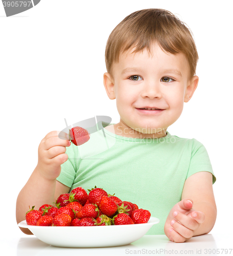 Image of Happy little boy with strawberries