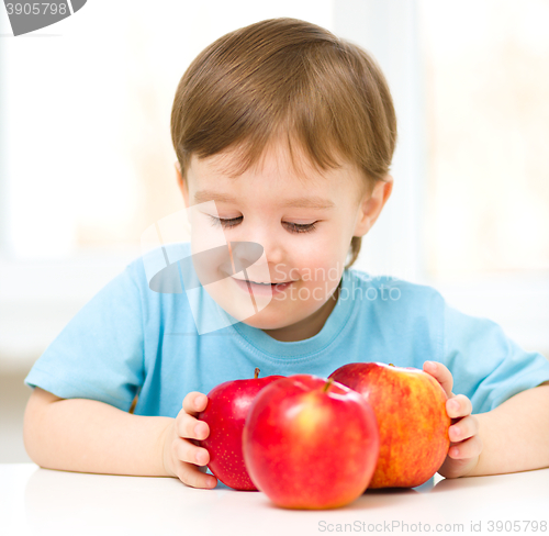 Image of Portrait of a happy little boy with apples