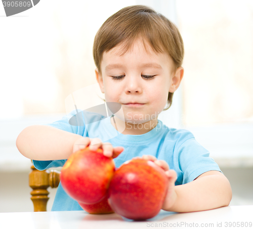 Image of Portrait of a happy little boy with apples