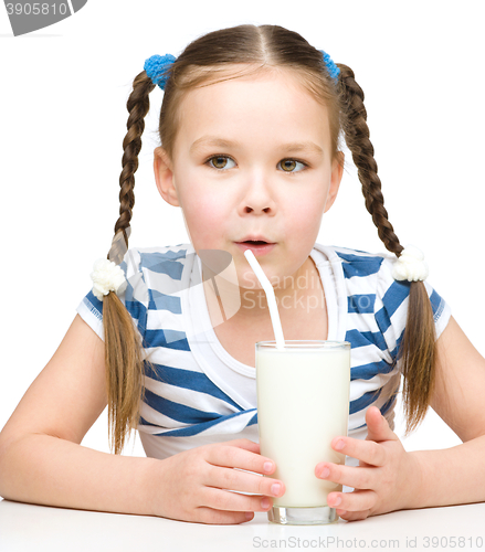 Image of Cute little girl with a glass of milk