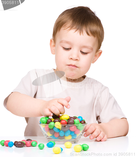 Image of Portrait of a boy with candies