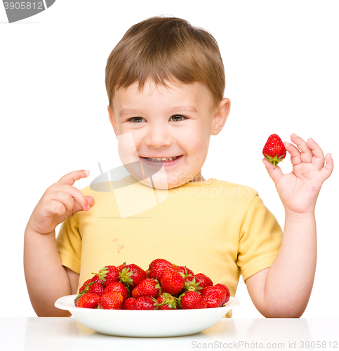 Image of Happy little boy with strawberries