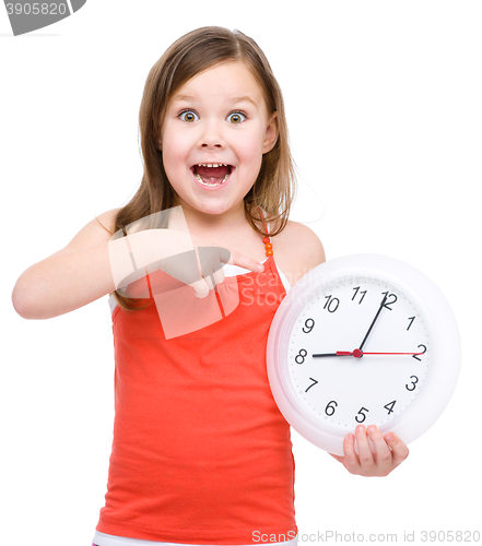 Image of Little girl is holding big clock