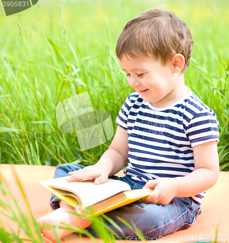 Image of Little boy is reading book