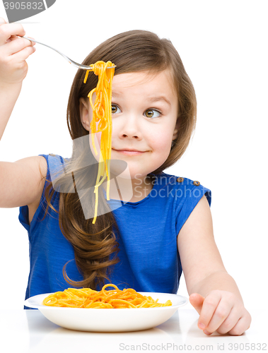 Image of Little girl is eating spaghetti