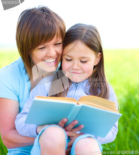 Image of Mother is reading book with her daughter