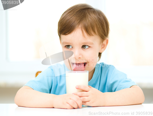 Image of Cute little boy with a glass of milk