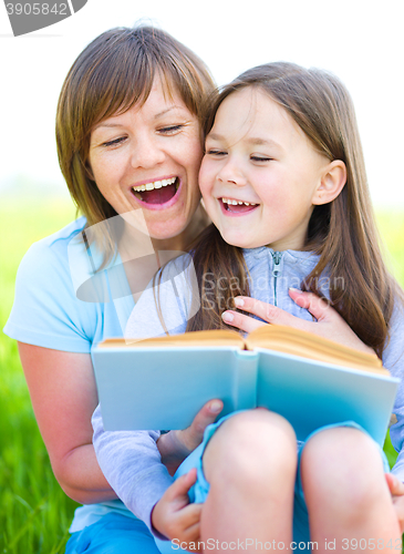 Image of Mother is reading book with her daughter