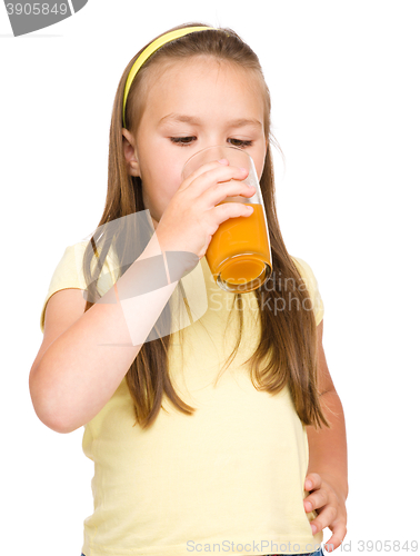 Image of Little girl is drinking orange juice