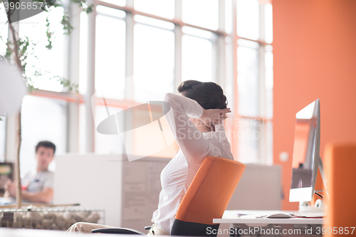 Image of happy young business woman relaxing and geting insiration