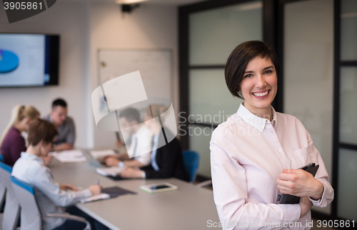 Image of hispanic businesswoman with tablet at meeting room