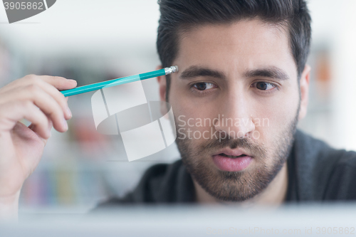 Image of student in school library using laptop for research