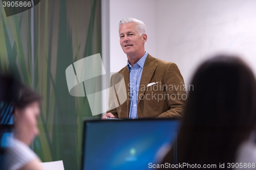 Image of teacher and students in computer lab classroom