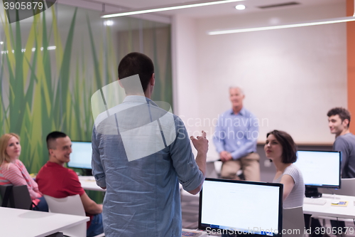 Image of student answering a question in classroom