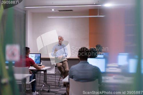 Image of teacher and students in computer lab classroom