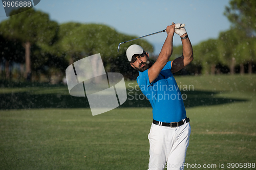 Image of pro golfer hitting a sand bunker shot