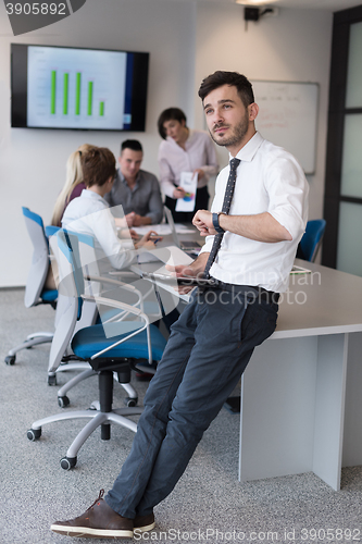 Image of young business man with tablet at office meeting room