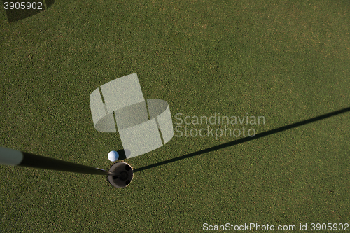 Image of top view of golf ball in the hole